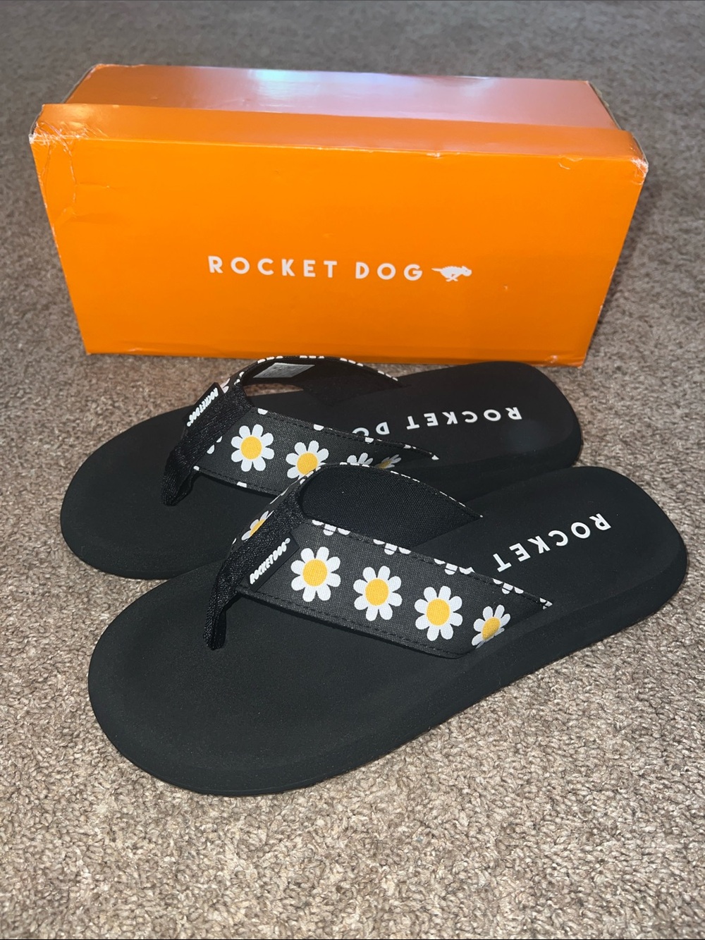 Rocket Dog Black Flip Flops with White & Yellow Daisy Detail